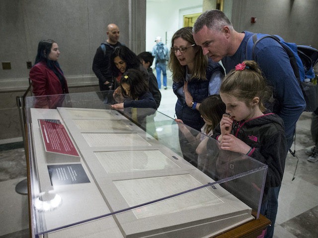People look at the Emancipation Proclamation at the National Archives on April 16, 2019, in Washington, DC. The National Archives displayed the document along with the Emancipation Act, which ended slavery in Washington D.C., in honor of Emancipation Day. (Zach Gibson/Getty Images)