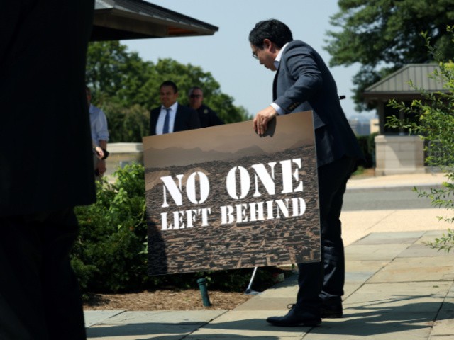 Rep. Andy Kim (D-NY) picks up a sign at a bipartisan news conference on the ongoing Afghanistan evacuations, at the U.S. Capitol on August 25, 2021 in Washington, DC. Kim urged President Biden to continue to evacuate all American's and those with special immigrant visas. (Photo by Kevin Dietsch/Getty Images)