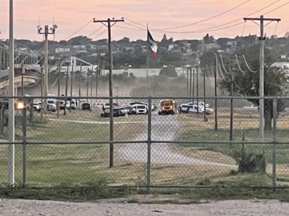 A Texas school bus arrives to begin moving migrants from the Del Rio Camp. (Photo: U.S. Bo