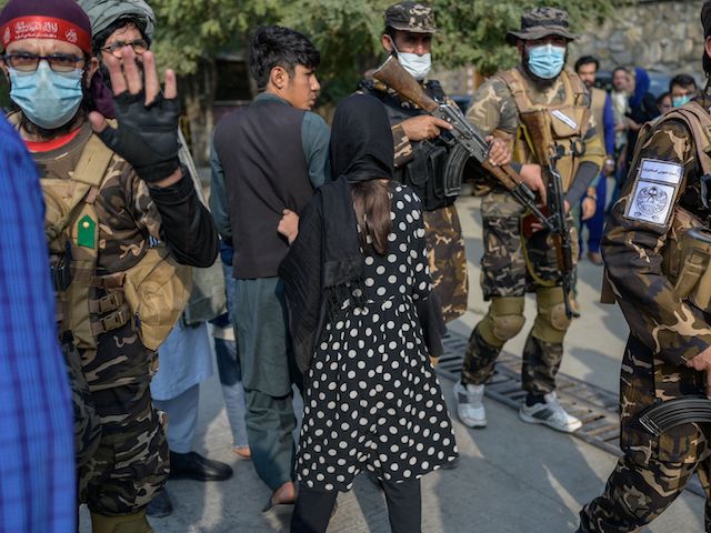 A Taliban fighter gestures asking photojournalists to stop covering a demonstration by women protestors in Kabul on September 30, 2021. (Bulent Kilic/AFP via Getty Images)