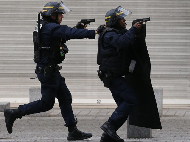 FILE - In this Nov. 18, 2015 file photo armed police operate in Saint-Denis, a northern suburb of Paris, Wednesday, Nov. 18, 2015. (AP Photo/Francois Mori)