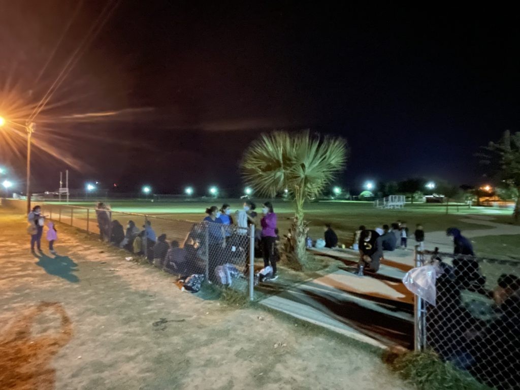 A large migrant group awaits transportation after an initial screening by Border Patrol agents.(Photo: Randy Clark/Breitbart Texas)