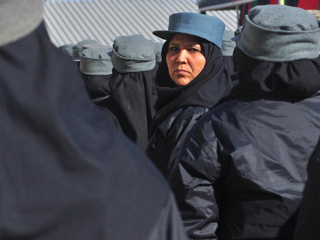 An Afghan policewoman stands in formation during a graduation ceremony at a police trainin