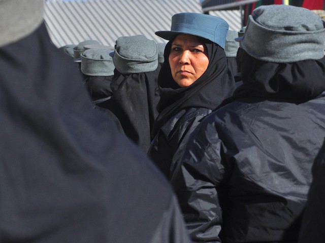 An Afghan policewoman stands in formation during a graduation ceremony at a police training centre in Herat on December 22, 2011. Some 500 officers graduated following their eight-week training course at Ansar 606 police training centre in the western province of Herat. AFP PHOTO / Aref Karimi (Photo credit should read Aref Karimi/AFP via Getty Images)