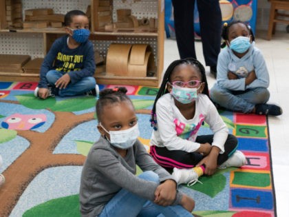 Pre-K students listen while a book is read to them at Phyl's Academy, Wednesday, March 24, 2021 in the Brooklyn borough of New York. Beginning in September the city's public schools, which currently serve 23,500 three-year-olds, will be adding an additional 16,500 kids to the 3K program. (AP Photo/Mark Lennihan, …