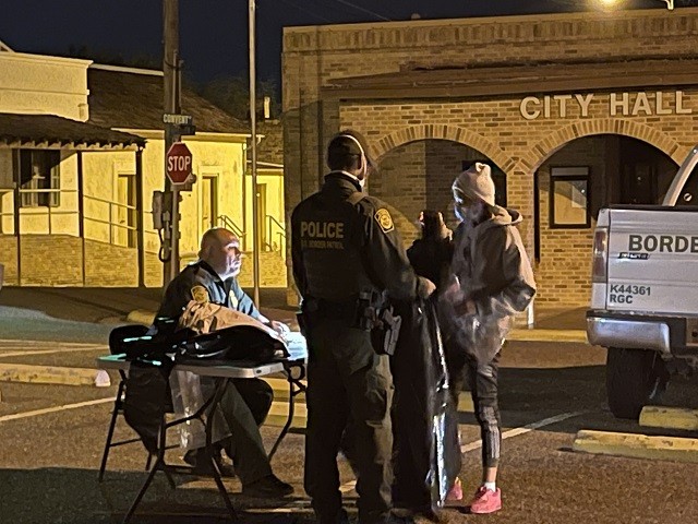A Border Patrol agent at a makeshift desk in Roma, Texas, records basic biographical data from migrants who crossed the border from Mexico. (Photo: Randy Clark/Breitbart Texas)