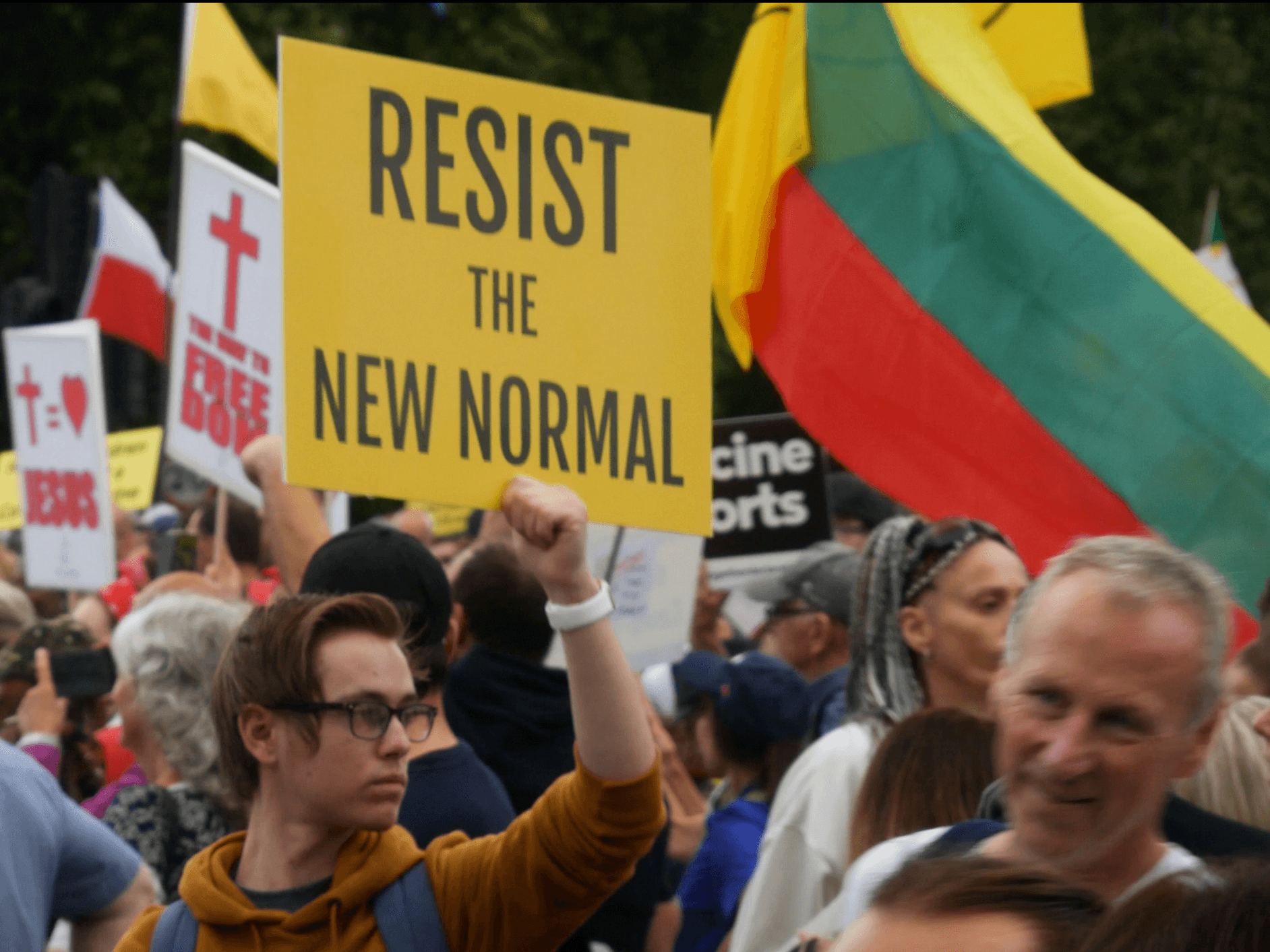 A protester is seen carrying a placard reading "Resist the New Normal" at a protest against vaccine passports in London. September 25th, 2021. Kurt Zindulka, Breitbart News