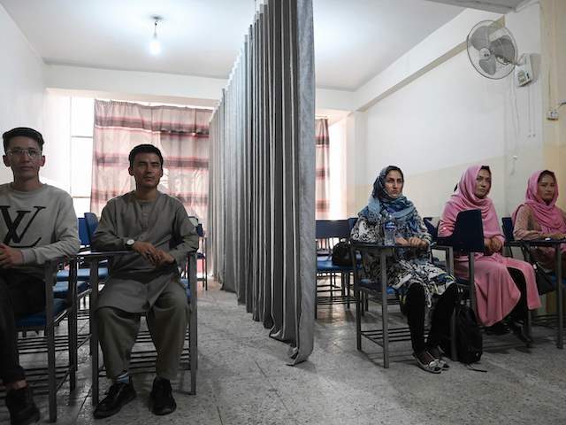 TOPSHOT - Students attend a class bifurcated by a curtain separating males and females at a private university in Kabul on September 7, 2021, to follow the Taliban's ruling. (Photo by Aamir QURESHI / AFP) (Photo by AAMIR QURESHI/AFP via Getty Images)