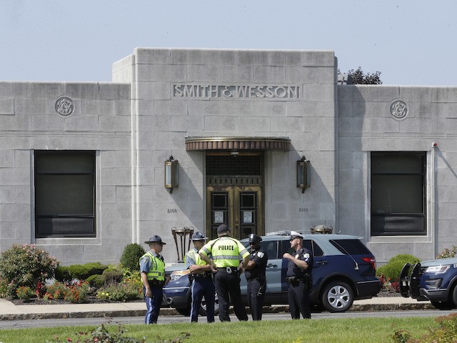 Law enforcement officers stand near an entrance to the headquarters of gun manufacturer Smith & Wesson, August 26, 2018, in Springfield, Massachusetts. (AP Photo/Steven Senne)
