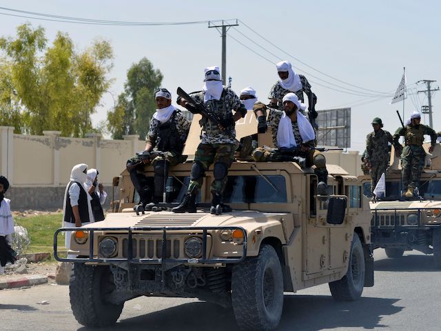 Taliban fighters atop Humvee vehicles parade along a road to celebrate after the US pulled all its troops out of Afghanistan, in Kandahar on September 1, 2021 following the Taliban’s military takeover of the country. (Photo by JAVED TANVEER/AFP via Getty Images)