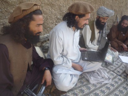 New Pakistani Taliban chief Hakimullah Mehsud, center, holds a laptop computer, flanked by his comrades in Sararogha of Pakistani tribal area of South Waziristan along Afghanistan border on October 4, 2009. Mehsud vowed to strike back at Pakistan and the U.S. for the increasing number of drone attacks in the …