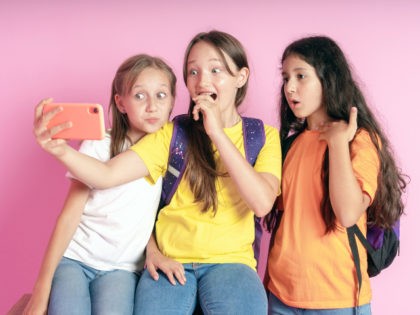 Three girls watching TikTok videos