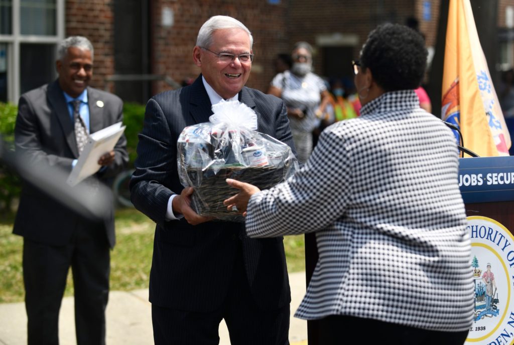 Senator Bob Menendez presents U.S. Housing Secretary Marcia Fudge with a gift basket of New Jersey specialty items during a press conference announcing a $35 million grant to the City of Camden. June 2, 2021. Hud Grant Marcia Fudge Ablett Village Camden Nj 10