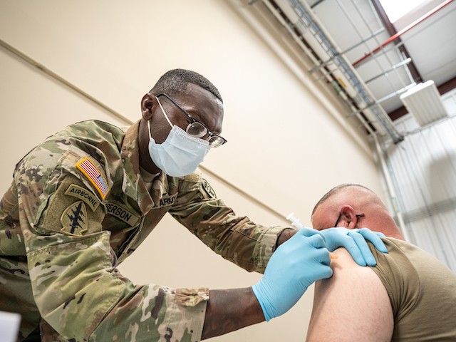 FORT KNOX, KY - SEPTEMBER 09: Preventative Medicine Services NCOIC Sergeant First Class Demetrius Roberson administers a COVID-19 vaccine to a soldier on September 9, 2021 in Fort Knox, Kentucky. The Pentagon, with the support of military leaders and U.S. President Joe Biden, mandated COVID-19 vaccination for all military service members in early September. The Pentagon stresses inoculation from COVID-19 and other diseases to avoid outbreaks from impeding the fighting force of the US Military. (Photo by Jon Cherry/Getty Images)