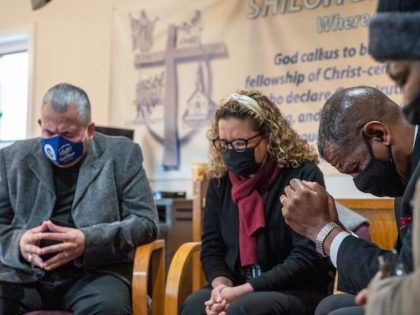 (L-R) Religious leaders Bishop Hector Hernandez, Pastor Yolanda Hernandez and Pastor Carl McCluster pray with Earlee Green at Shiloh Baptist Church before heading to receive their vaccinations against Covid-19 in Bridgeport, Connecticut on February 26, 2021. - Nine local clergy members were given the Pfizer-BioNTech Covid-19 Vaccine, aiming to educate …