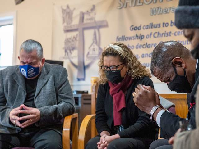 (L-R) Religious leaders Bishop Hector Hernandez, Pastor Yolanda Hernandez and Pastor Carl McCluster pray with Earlee Green at Shiloh Baptist Church before heading to receive their vaccinations against Covid-19 in Bridgeport, Connecticut on February 26, 2021. - Nine local clergy members were given the Pfizer-BioNTech Covid-19 Vaccine, aiming to educate and inspire their parishioners and minority communities to get vaccinated. (Photo by Joseph Prezioso / AFP) (Photo by JOSEPH PREZIOSO/AFP via Getty Images)
