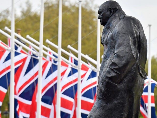 Union flags fly near a bronze statue of British war-time Prime Minister Winston Churchill, by sculptor Ivor Roberts-Jones, in Parliament Square in London on May 11, 2021. (Photo by JUSTIN TALLIS / AFP) (Photo by JUSTIN TALLIS/AFP via Getty Images)
