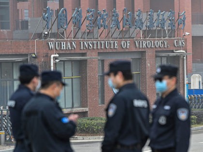 Security personnel stand guard outside the Wuhan Institute of Virology in Wuhan as members of the World Health Organization (WHO) team investigating the origins of the COVID-19 coronavirus make a visit to the institute in Wuhan in China's central Hubei province on February 3, 2021. (Photo by Hector RETAMAL / …