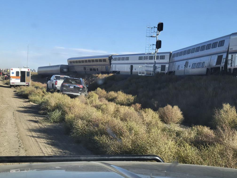 In this photo provided by Kimberly Fossen an ambulance is parked at the scene of an Amtrak train derailment on Saturday, Sept. 25, 2021, in north-central Montana. Multiple people were injured when the train that runs between Seattle and Chicago derailed Saturday, the train agency said. (Kimberly Fossen via AP)
