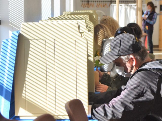 Jason Goodman and several other voters make their choices at Oconto City Hall on Tuesday. It was Goodman's first time voting in Wisconsin after moving from California. Oconto4 4872