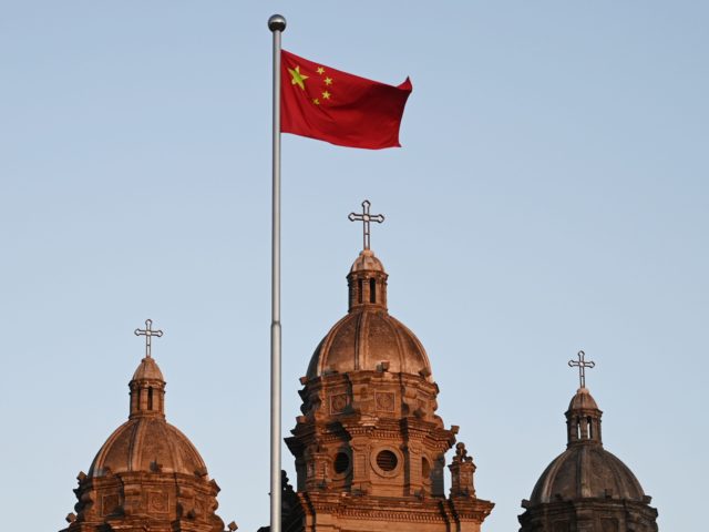 The Chinese national flag flies in front of St Joseph's Church, also known as Wangfujing C