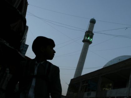 A boy walks next to Puli Kheshti mosque in Kabul, Afghanistan, Wednesday, March 29, 2006.