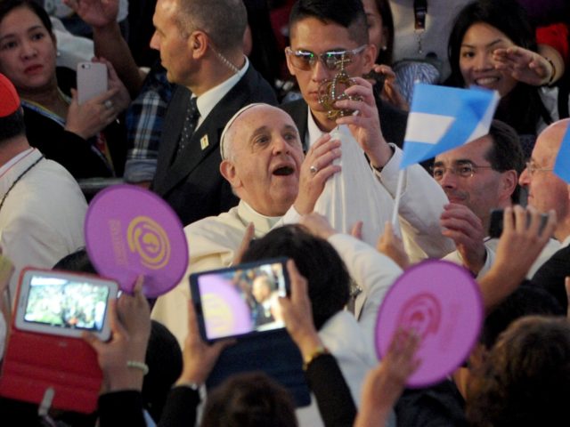 In this picture taken on January 16, 2015, Pope Francis holds a religious icon as he arrives to meet Filipino families at the Mall of Asia Arena in Manila. Pope Francis will spend an emotional day in the Philippines on January 17 with survivors of a catastrophic super typhoon that …