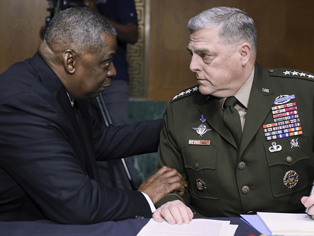 In this June 17, 2021 file photo, Secretary of Defense Lloyd Austin, left, and Chairman of the Joint Chiefs Chairman Gen. Mark Milley talk before a Senate Appropriations Committee hearing on Capitol Hill in Washington. In their first public testimony on Afghanistan since the U.S. completed its withdrawal on Aug. 30, Austin and Milley are appearing before the Senate Armed Services Committee on Tuesday, along with Gen. Frank McKenzie, who as head of Central Command oversaw the withdrawal as well as an Aug. 29 drone strike that he later called a tragic mistake. (Evelyn Hockstein/Pool via AP)