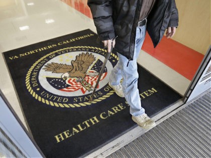 FILE - In this April 2, 2015, file photo, a visitor leaves the Sacramento Veterans Affairs Medical Center in Rancho Cordova, Calif. The number of veterans seeking health care but ending up on waiting lists of one month or more is 50 percent higher now than it was a year …