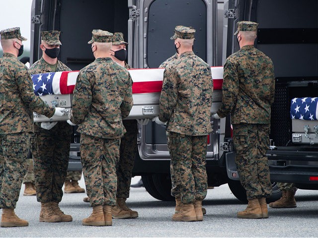 A flag-draped transfer case with the remains of a fallen service member are placed inside a transfer vehicle as US President Joe Biden attends the dignified transfer of the remains of a fallen service member at Dover Air Force Base in Dover, Delaware, August, 29, 2021, one of the 13 …