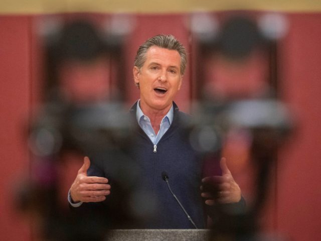 California Governor Gavin Newsom is live-streamed as he speaks at a press conference held