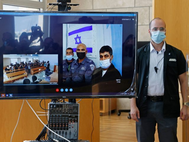 Palestinian militant Mohammad Ardah (screen-R) attends via Zoom a court session in the Isr