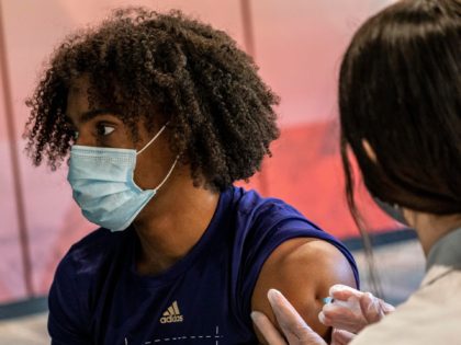 SEATTLE, WA - MAY 18: Kyler Gordon, a student athlete on the football team, receives a COVID-19 vaccine at a vaccination clinic on the University of Washington campus on May 18, 2021 in Seattle, Washington. The two-day clinic, in partnership with Safeway, Dicks Drive-In Restaurants, and the Seattle Metropolitan Chamber …