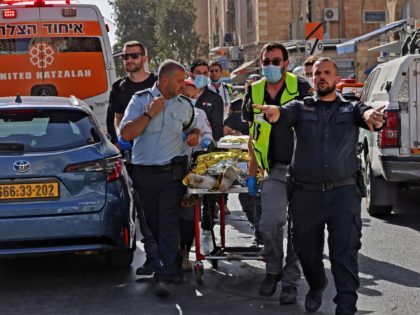Israeli medics stretch off a wounded Palestinian man, who stabbed two Israelis, in Jerusalem on September 13, 2021. - A police spokesman told AFP the assailant was a Palestinian man from the West Bank city Hebron. There was no immediate indication about the condition of the assailant, who was seen …