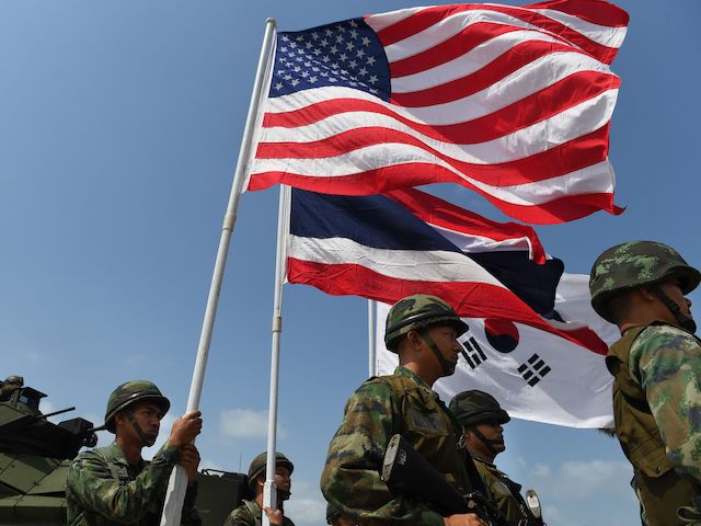 US, Thai (C) and South Korean flags are flown during an amphibious landing in Chonburi on February 16, 2019, at the multi-nation Cobra Gold military exercises. (Lillian Suwanrumpha/AFP via Getty Images)