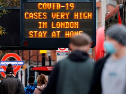 Pedestrians, some wearing a face mask or covering due to the COVID-19 pandemic, walks past a sign alerting people that "COVID-19 cases are very high in London - Stay at Home", in central London on December 23, 2020. - Britain's public health service urged Prime Minister Boris Johnson on Wednesday …