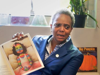 Chicago Mayor Lori Lightfoot reads a book to children at Breakthrough, a nonprofit that pa