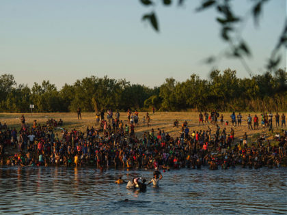 Haitian migrants are pictured on the banks of the Rio Grande in Del Rio, Texas, as seen fr