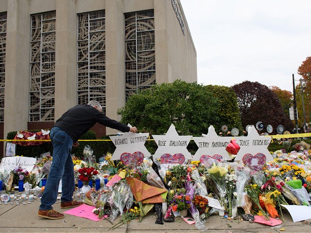 PITTSBURGH, PA - OCTOBER 31: Mourners visit the memorial outside the Tree of Life Synagogue on October 31, 2018 in Pittsburgh, Pennsylvania. Eleven people were killed in a mass shooting at the Tree of Life Congregation in Pittsburgh's Squirrel Hill neighborhood on October 27. (Photo by Jeff Swensen/Getty Images)