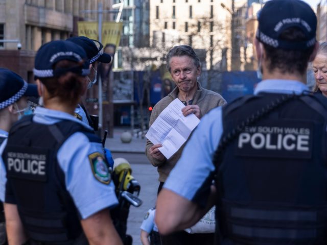 SYDNEY, AUSTRALIA - AUGUST 31: Police speak to a small group of protestors outside the Parliament of New South Wales on Macquarie Street on August 31, 2021 in Sydney, Australia. A small group of protestors took part in a so called ‘silent-protest’ against lockdown measures, with a number of arrests …