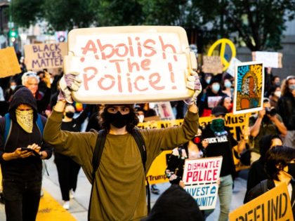 OAKLAND, CALIFORNIA - JULY 25: Protesters hold signs in support of defunding the police on July 25, 2020 in Oakland, California. Demonstrators in Oakland gathered to protest in solidarity with Portland protests. (Photo by Natasha Moustache/Getty Images)