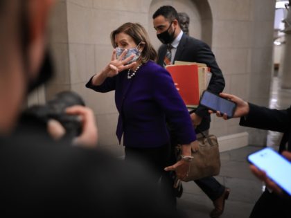 WASHINGTON, DC - SEPTEMBER 27: Speaker of the House Nancy Pelosi (D-CA) holds up four fingers to reporters as she arrives at the U.S. Capitol on September 27, 2021 in Washington, DC. Pelosi and members of the House Democratic caucus will meet Monday to discuss the way forward on legislation …