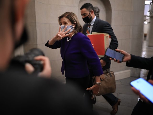 WASHINGTON, DC - SEPTEMBER 27: Speaker of the House Nancy Pelosi (D-CA) holds up four fing