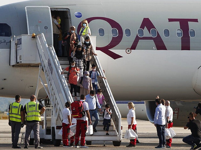 Afghan evacuees disembark the plane to board a bus after landing at Skopje International Airport, North Macedonia, on Wednesday, Sept. 15, 2021. North Macedonia has hosted another group of 44 Afghan evacuees on Wednesday where they will be sheltered temporarily till their transfer to final destinations. (AP Photo/Boris Grdanoski)
