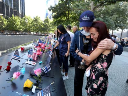 Sept 11, 2021; New York, NY, USA; Mercedes Arias, formerly of Yonkers, N.Y., is comforted by a 9/11 Museum staff member as she cries near the name of her father, Joseph Amatuccio at the 9/11 Memorial Sept. 11, 2021. Arias was attending the ceremony marking the 20th anniversary of the …