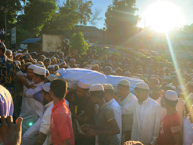 Rohingya refugees carry the body of Mohibullah, an international representative of ethnic