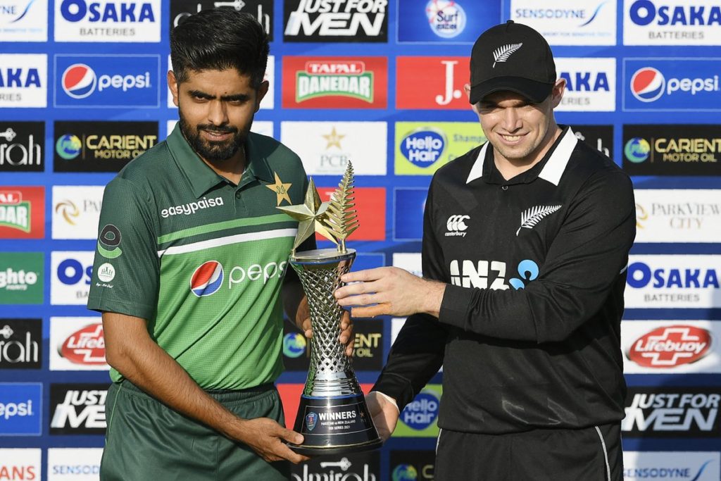 Pakistan's captain Babar Azam (L) and his counterpart New Zealand's Tom Latham pose for photographs with the series trophy during a ceremony at the Rawalpindi Cricket Stadium in Rawalpindi on September 16, 2021, a day before their first one-day international (ODI) cricket match. (Photo by Aamir QURESHI / AFP) (Photo by AAMIR QURESHI/AFP via Getty Images)
