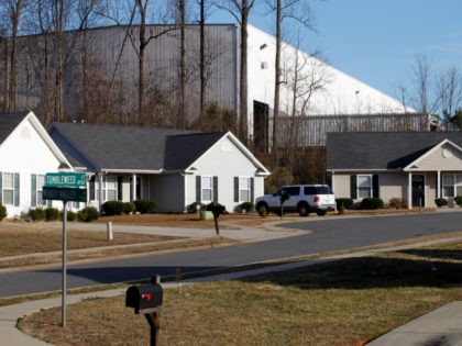 This Tuesday, Feb. 15, 2011 picture shows single family homes in the Windy Ridge subdivision in Charlotte, N.C. and the corner of a large industrial facility at the edge of the neighborhood. Many people sought the American Dream in starter homes here. But in this and a neighboring subdivision is …