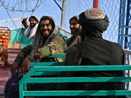 In this photograph taken on September 28, 2021 Taliban fighters enjoy a ride on a pirate ship attraction in a fairground at Qargha Lake on the outskirts of Kabul. - "This is Afghanistan!" a Taliban fighter shouts on the pirate ship ride at a fairground in western Kabul, as his …