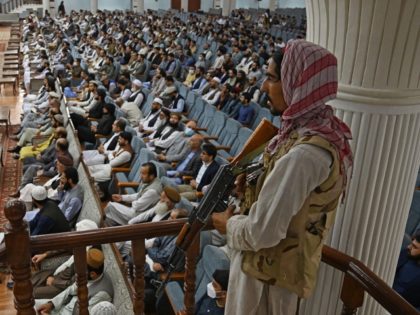 TOPSHOT - A Taliban fighter stands guard as Talibans acting Higher Education Minister Abdu